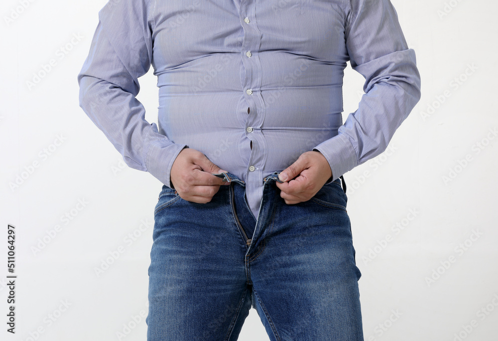 A fat man is struggling to wear tight pants and a shirt Stock