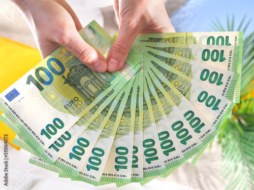 Fotografie Hands hold hundred euro banknotes