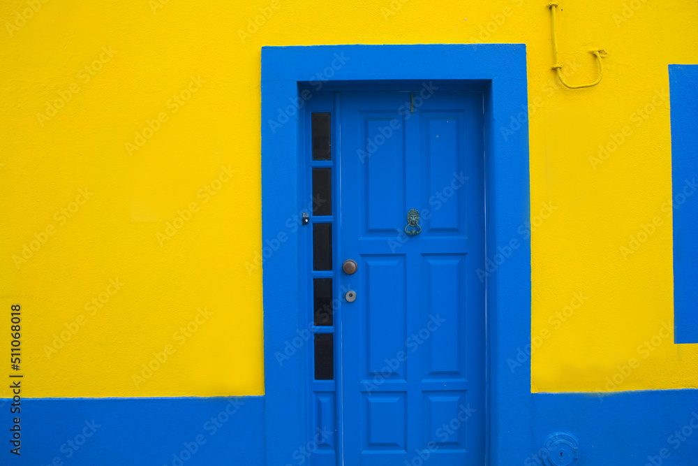 Blue door on the yellow wall Blue door on the yellow wall