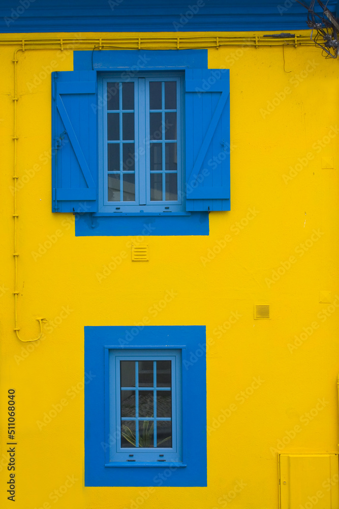 Blue window on the yellow wall