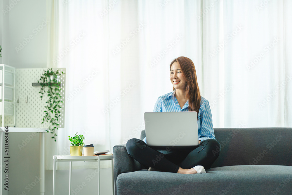 Asian business woman working with laptop on sofa. Asian business woman working with laptop on sofa.