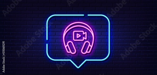 Neon light speech bubble. Headphones with video camera line icon. Online conference sign. Virtual education symbol. Neon light background. Headphones glow line. Brick wall banner. Vector