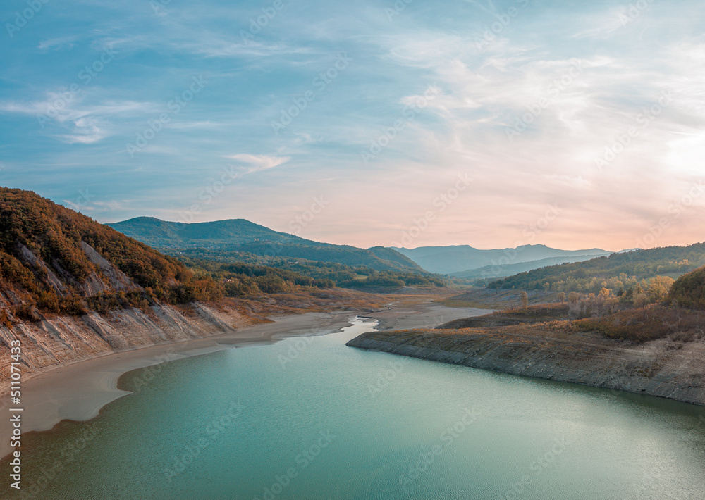 panoramic view of the lake formed by a dam in the summer period of drought