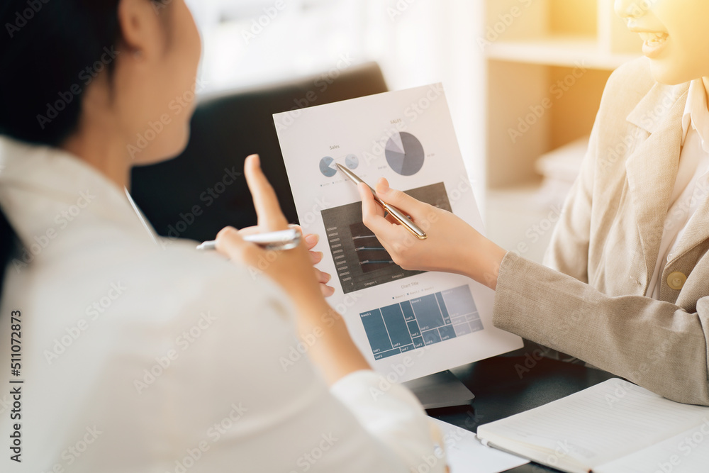 Business women using calculator at working with financial report. Business women using calculator at working with financial report.
