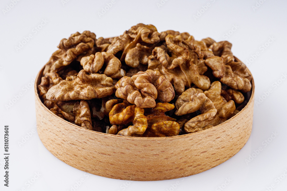 dried walnuts on a white acrylic background dried walnuts on a white acrylic background