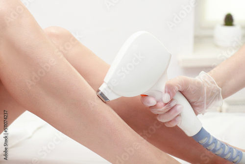 Diode laser hair removal, Beautician removes hair on female legs, laser procedure, Body care epilation treatment