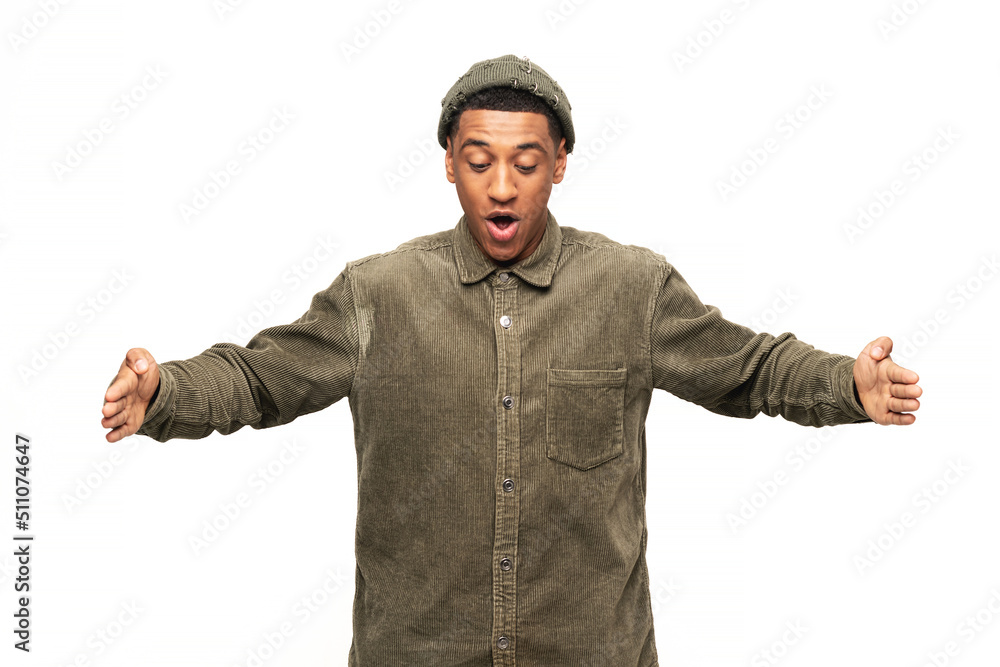 Shocked latin man posing over white background gesturing with hands and showing big and large size sign, measure symbol. Measuring concept Shocked latin man posing over white background gesturing with hands and showing big and large size sign, measure symbol. Measuring concept