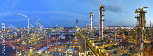 refinery - chemical factory at night with buildings, pipelines and lighting - industrial plant photo