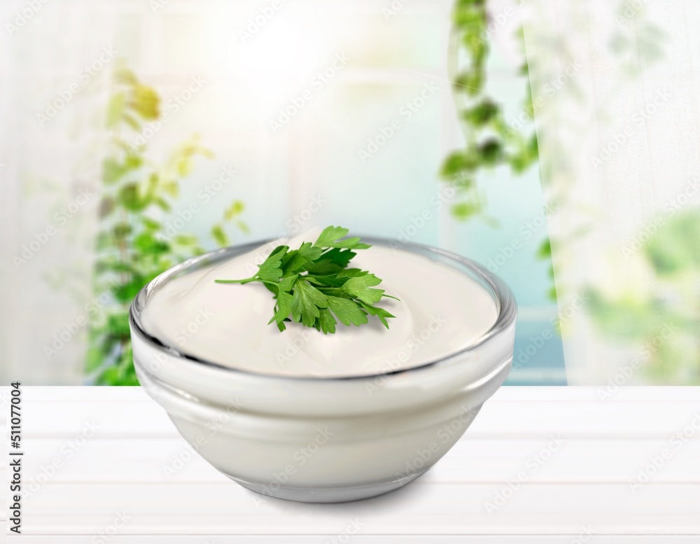 Bowl of tasty mayonnaise with parsley on the desk Bowl of tasty mayonnaise with parsley on the desk