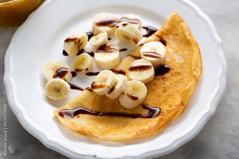 Breakfast crepes with banana and chocolate sauce pancake food Breakfast crepes with banana and chocolate sauce pancake food