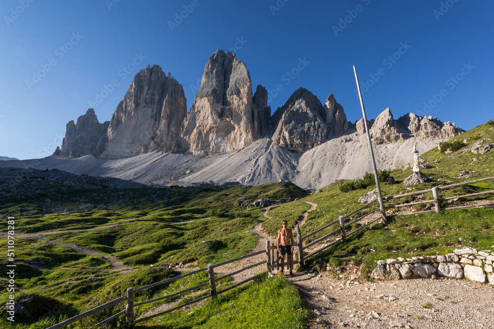 Male hiker below Tre cime di Lavaredo mountains - obrazy, fototapety, plakaty 