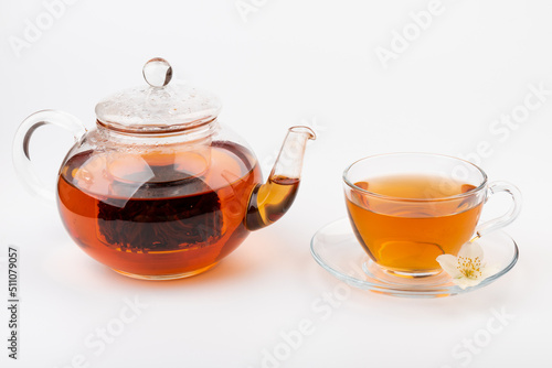 Composition with cup of jasmine tea and flowers on light background