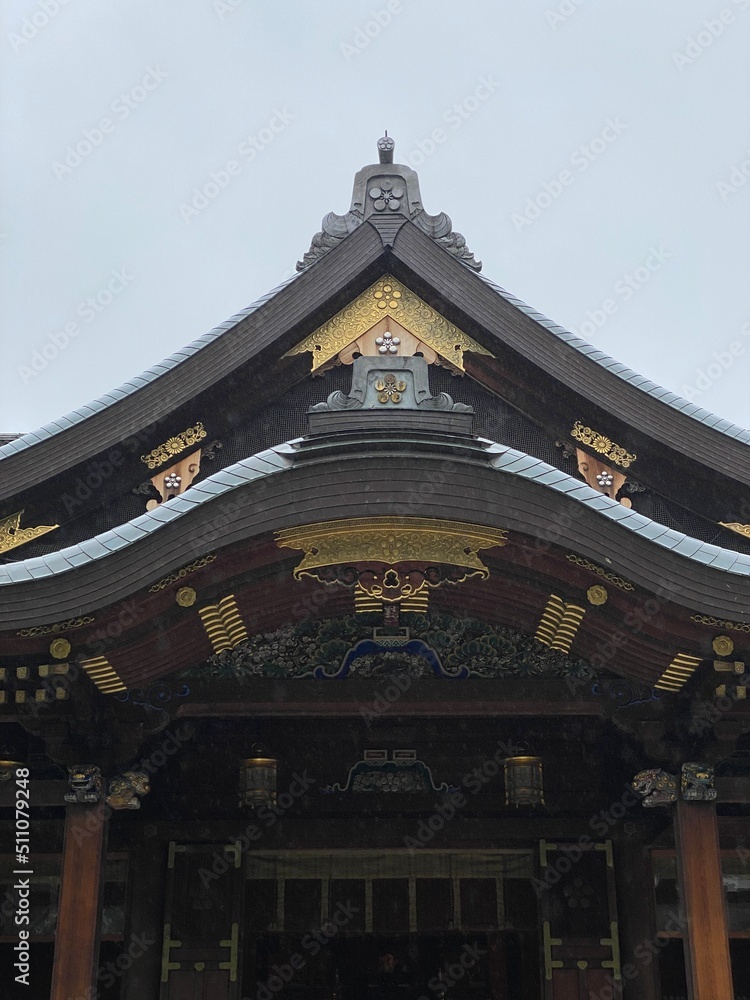 Fototapeta premium The main pagoda of Yushima Tenjin, the historic establishment in 458 the beautiful architecture with plum symbolic family crest “Kamon”. Photo taken year 2022 June 15th