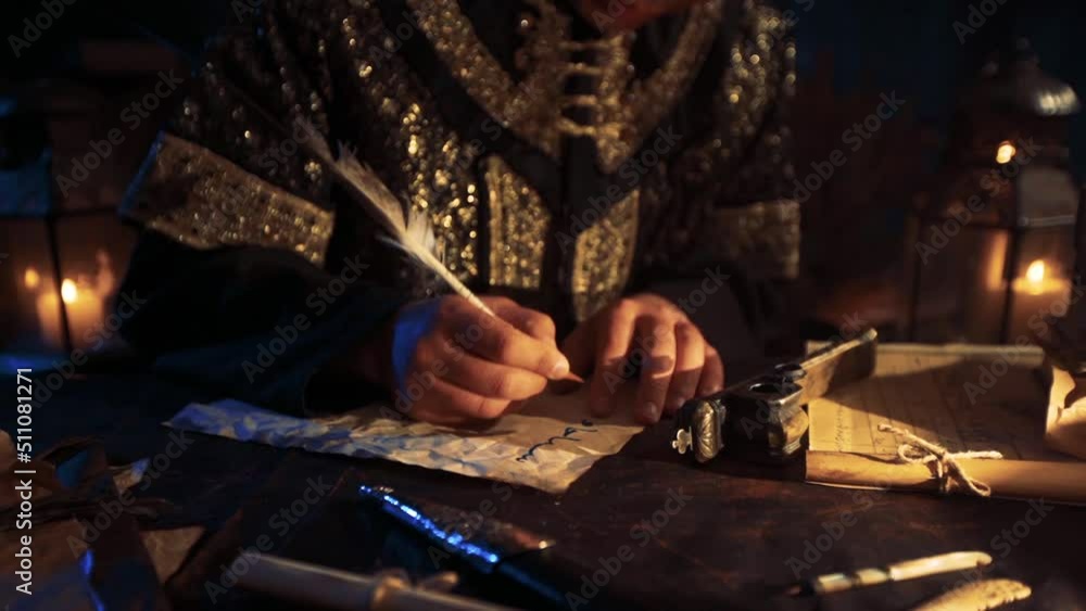 The man who wrote letters with historical objects in the old period. Ancient inkwell and pen. Parchment paper, Candlelight. Historical scene reenactment. The man who wrote letters with historical objects in the old period. Ancient inkwell and pen. Parchment paper, Candlelight. Historical scene reenactment.