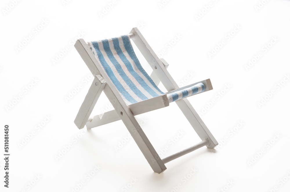 Beach chair, white blue striped deckchair isolated on white background. Beach chair, white blue striped deckchair isolated on white background.