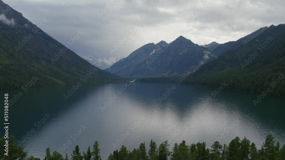 Multin lakes in the middle of mountains under dramatic sky in Altai, Siberia, Russia. Beautiful summer nature landscape at pre storm daytime. Aerial view from a drone Multin lakes in the middle of mountains under dramatic sky in Altai, Siberia, Russia. Beautiful summer nature landscape at pre storm daytime. Aerial view from a drone