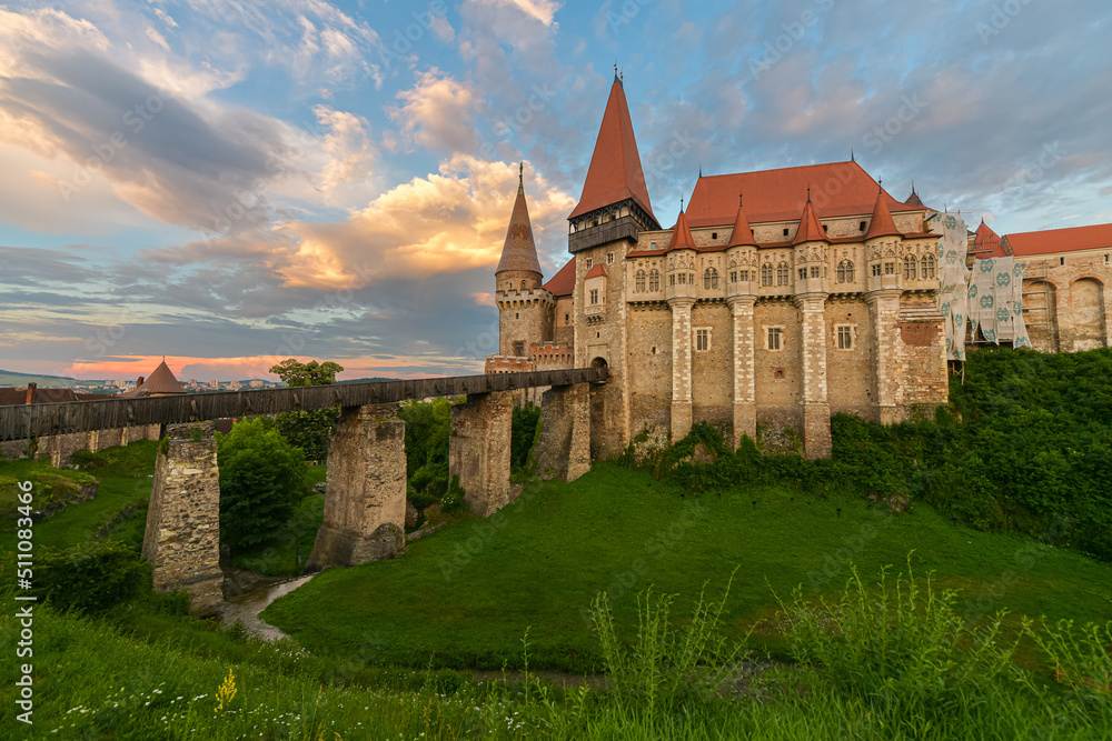 Beautiful summer sunset at Corvin (Hunyad) Castle in Hunedoara, an amazing landmark from Transylvania, one of the biggest castles in Europe. Travel to Romania.