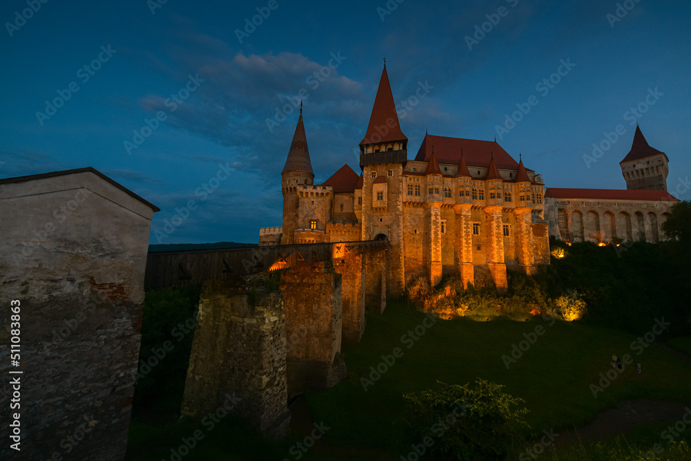 Fototapeta premium Night landscape at Corvin (Hunyad) Castle in Hunedoara, an amazing landmark from Transylvania, one of the biggest castles in Europe. Travel to Romania.
