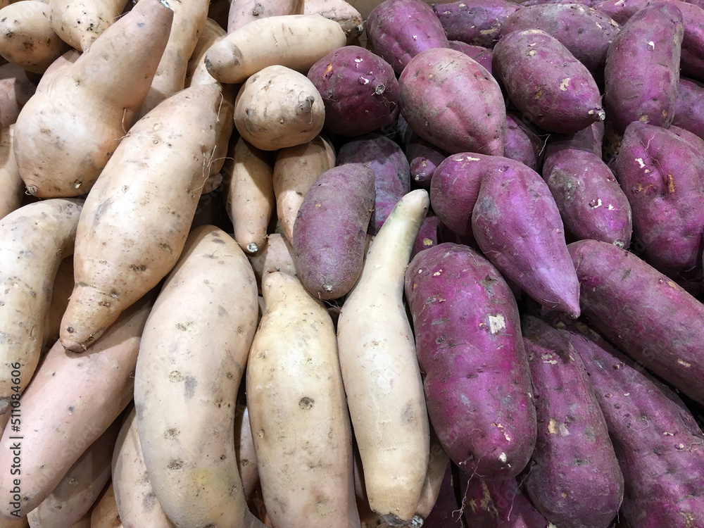 Organic Yams and Japanese Potatoes at a market stand Organic Yams and Japanese Potatoes at a market stand