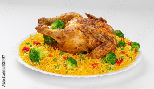 Full Chargha (Whole Grilled Chicken) with Vegetables and Saffron Rice. Extremely Delicious and Spicy Food. This food also called Mandee in Arab Countries.