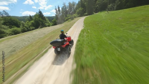 ATV quad bike on a forest macadam path - an attractive shot of pursuit with an FPV drone #3