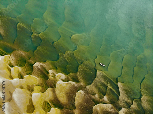 Huge sandbars arise in river Jamuna when the water level drops during the dry season. The striking pattern and textures look like desert when seen from above. Aerial sandbar view. Beauty of Nature. photo