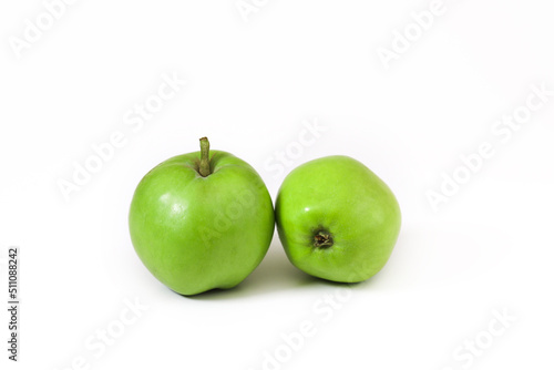Small green apples on a white background. Close-up