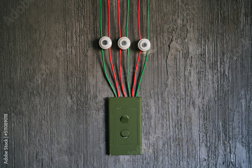 Red and green cable arrange perfectionist neatly on the cement wall. photo
