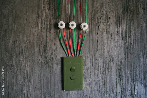 Fényképezés Red and green cable arrange perfectionist neatly on the cement wall