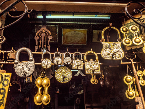 Beautiful antique locks and traditional Gnawa iron castanets are displayed for purchase  in a shop in the Marrakech Medina.