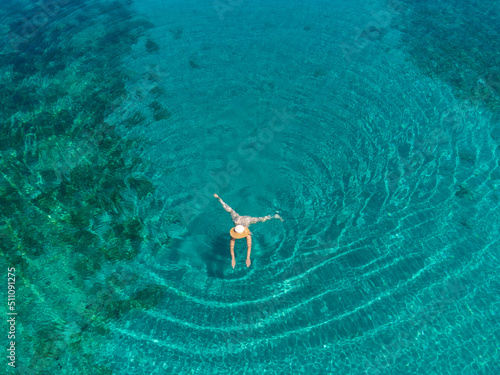 Obraz na płótnie drone view of woman swimming in turquoise blue sea on island Molat, Croatia w salonie