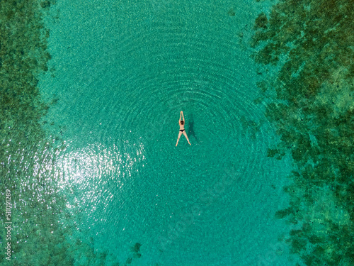 Obraz na płótnie drone view of woman swimming in turquoise blue sea on island Molat, Croatia w salonie