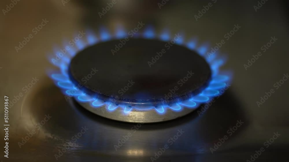 Burning gas, gas stove burner, hob in the kitchen. The concept of problems with natural gas, rising gas prices, and wastage. Burning gas, gas stove burner, hob in the kitchen. The concept of problems with natural gas, rising gas prices, and wastage.