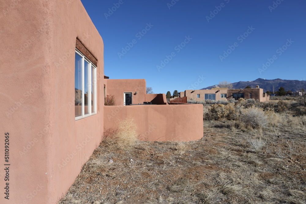 pueblo style home exterior with windows