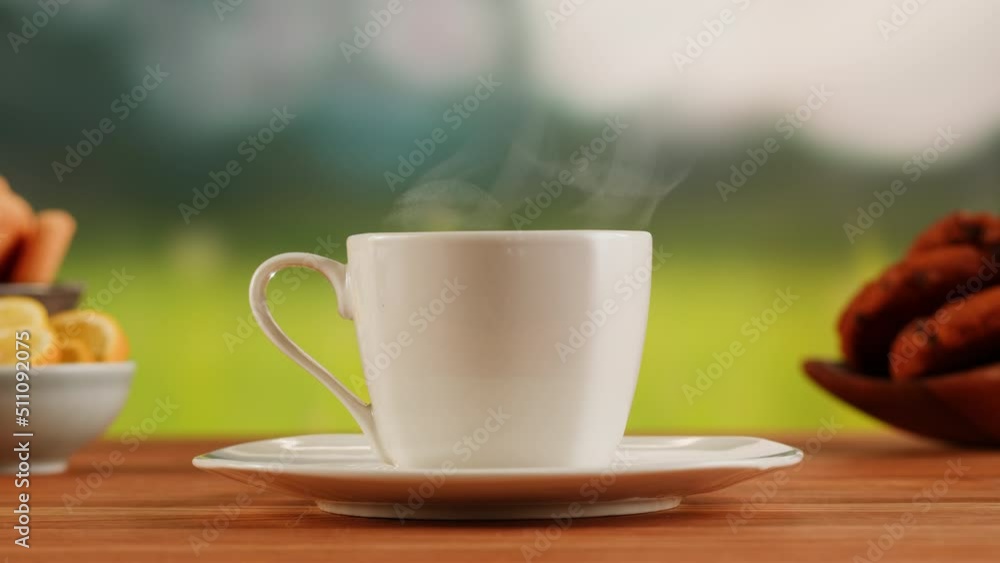 Hot drink in white cup on a wooden table. Tea ceremony process, drinking coffee, healthy morning, freshly brewed detox tea. Hot drink in white cup on a wooden table. Tea ceremony process, drinking coffee, healthy morning, freshly brewed detox tea.