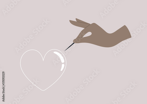 A hand piercing a heart with a needle, a breakup concept, unrequited love