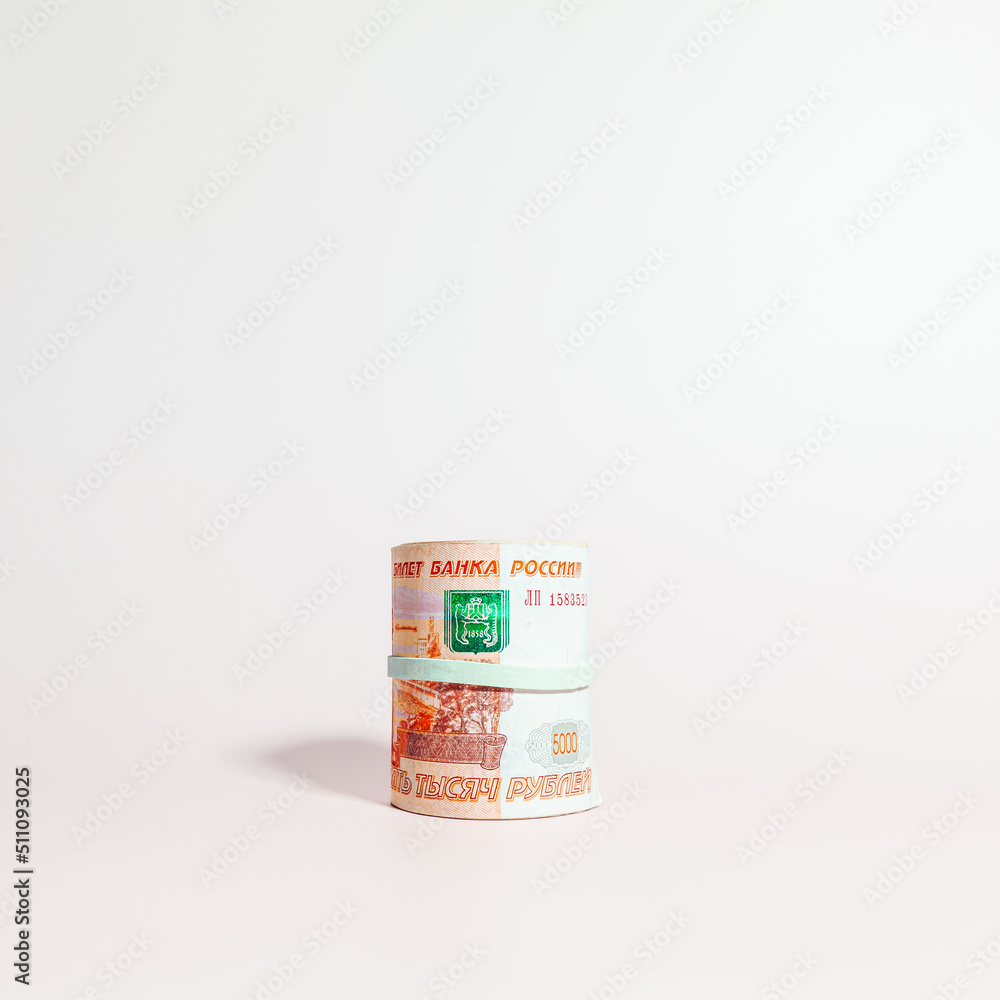 A bundle of Russian paper money in denominations of 5 thousand rubles, rolled up, side view A bundle of Russian paper money in denominations of 5 thousand rubles, rolled up, side view