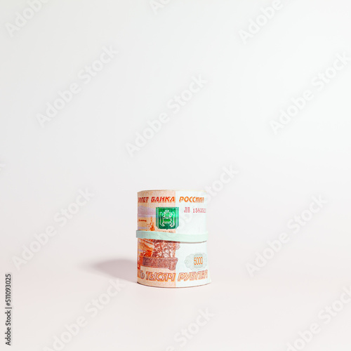 A bundle of Russian paper money in denominations of 5 thousand rubles, rolled up, side view