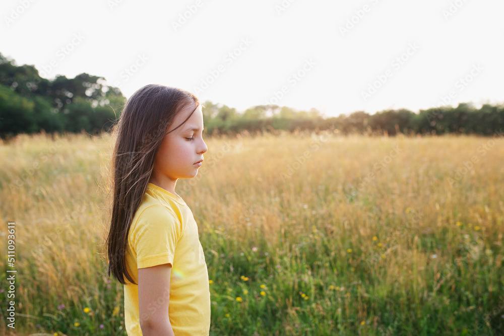 Happy little girl in the green meadow on a sunny summer day, child happiness Happy little girl in the green meadow on a sunny summer day, child happiness