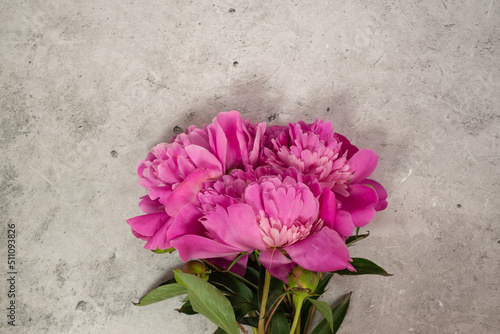 Bouquet of peonies on a concrete background. empty space for text.