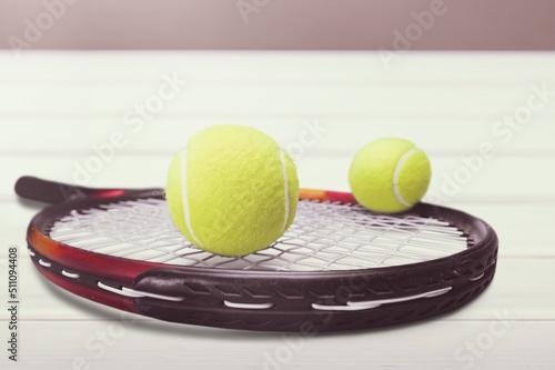 Black professional tennis racket and ball on background. Sport theme poster © BillionPhotos.com