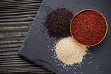 tricolor quinoa seeds on a dark rustic background