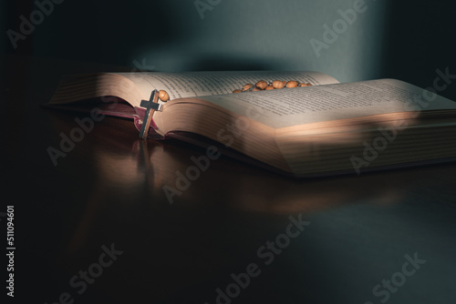 Cross on the holy bible on a wooden table Fototapet