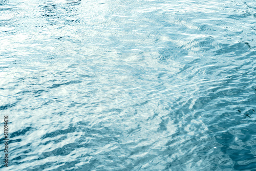 Water surface with ripples and sunlight reflections