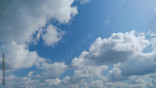 Summer blue sky with fluffy white clouds. White clouds float across the blue sky. photo