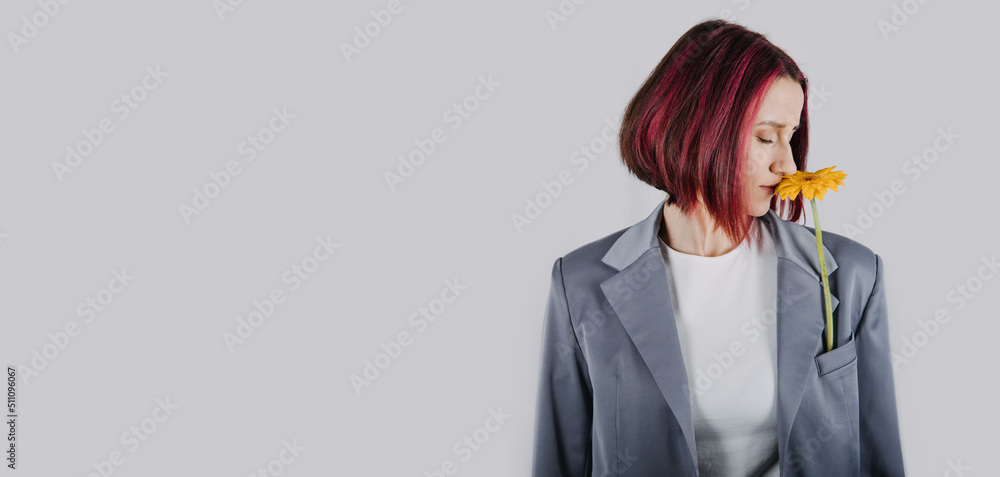 Unaltered candid portrait of young happy young woman with bright red hair with yellow flower Unaltered candid portrait of young happy young woman with bright red hair with yellow flower