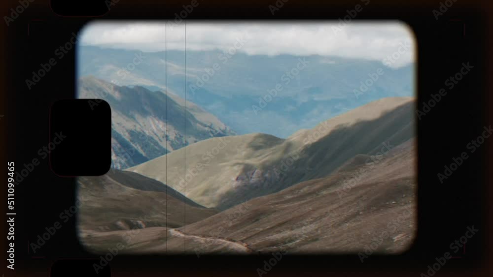Retro photo camera screen with road and horses in mountains of Dombay in national park of Caucasus, Russia. Summer landscape with dramatic sky Retro photo camera screen with road and horses in mountains of Dombay in national park of Caucasus, Russia. Summer landscape with dramatic sky