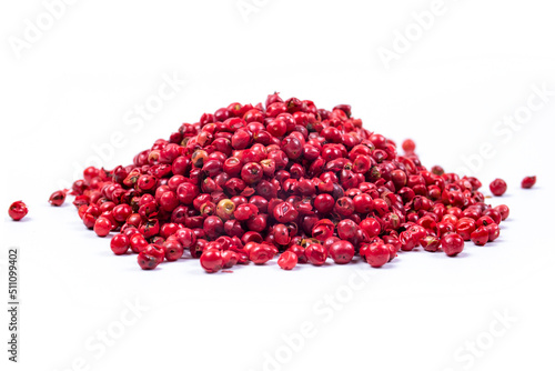 pile of pink peppercorns isolated on white background photo