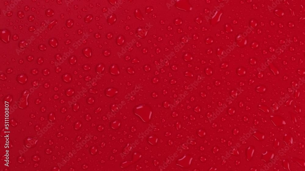 Rotating red background with water drops top view Rotating red background with water drops top view