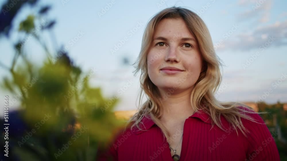 a young woman happily picks flowers on the mountain hills during sunset, for rest after a hike. rest of one person in nature, in the mountains. a young woman happily picks flowers on the mountain hills during sunset, for rest after a hike. rest of one person in nature, in the mountains.